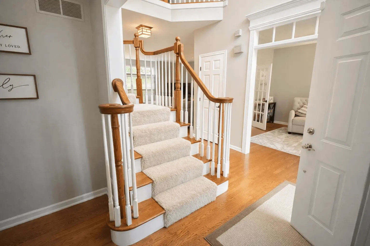 Professional painting project — Bright Foyer Curved Staircase