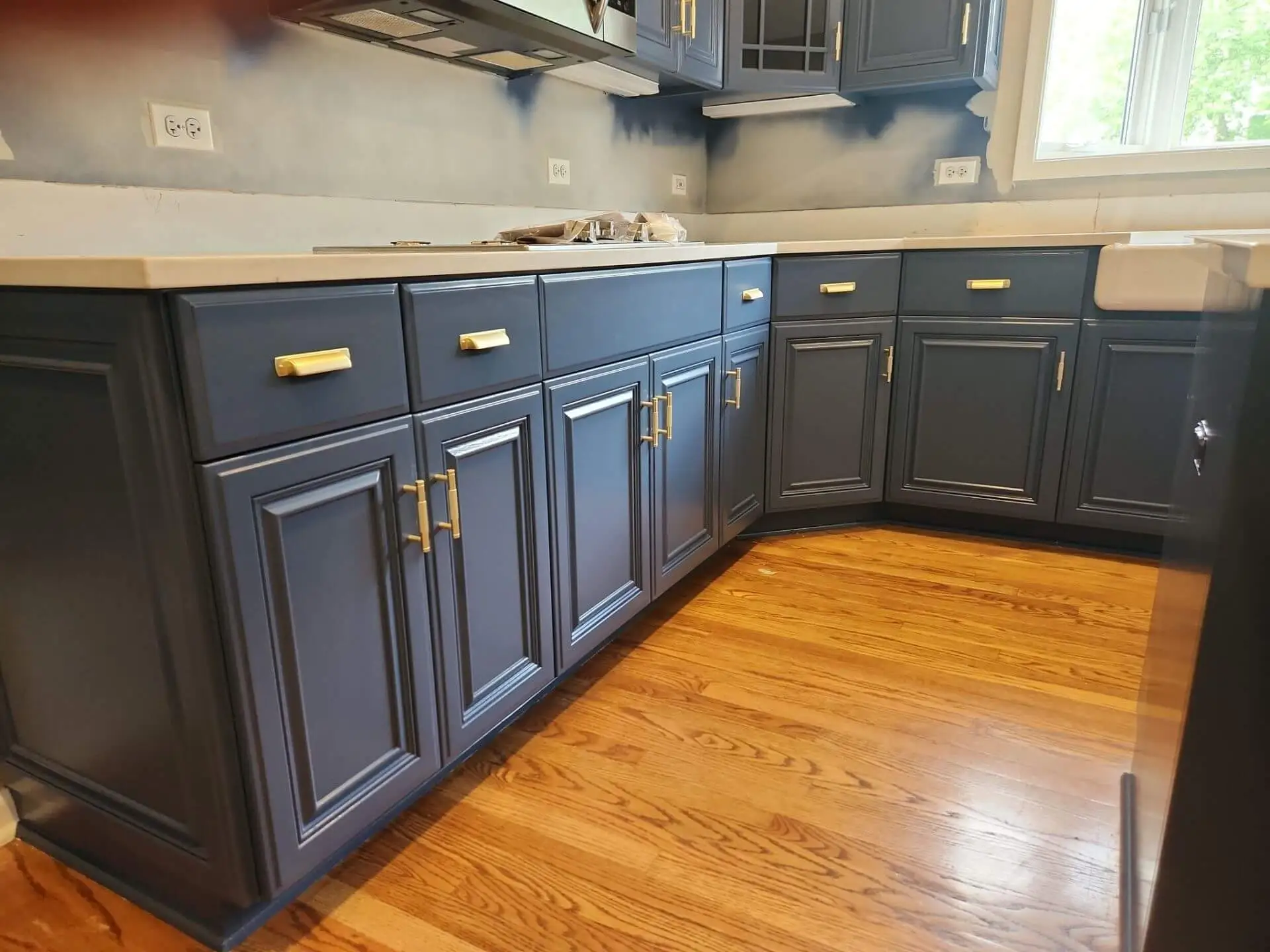 Professional painting project — Navy Kitchen Cabinets Brass Hardware