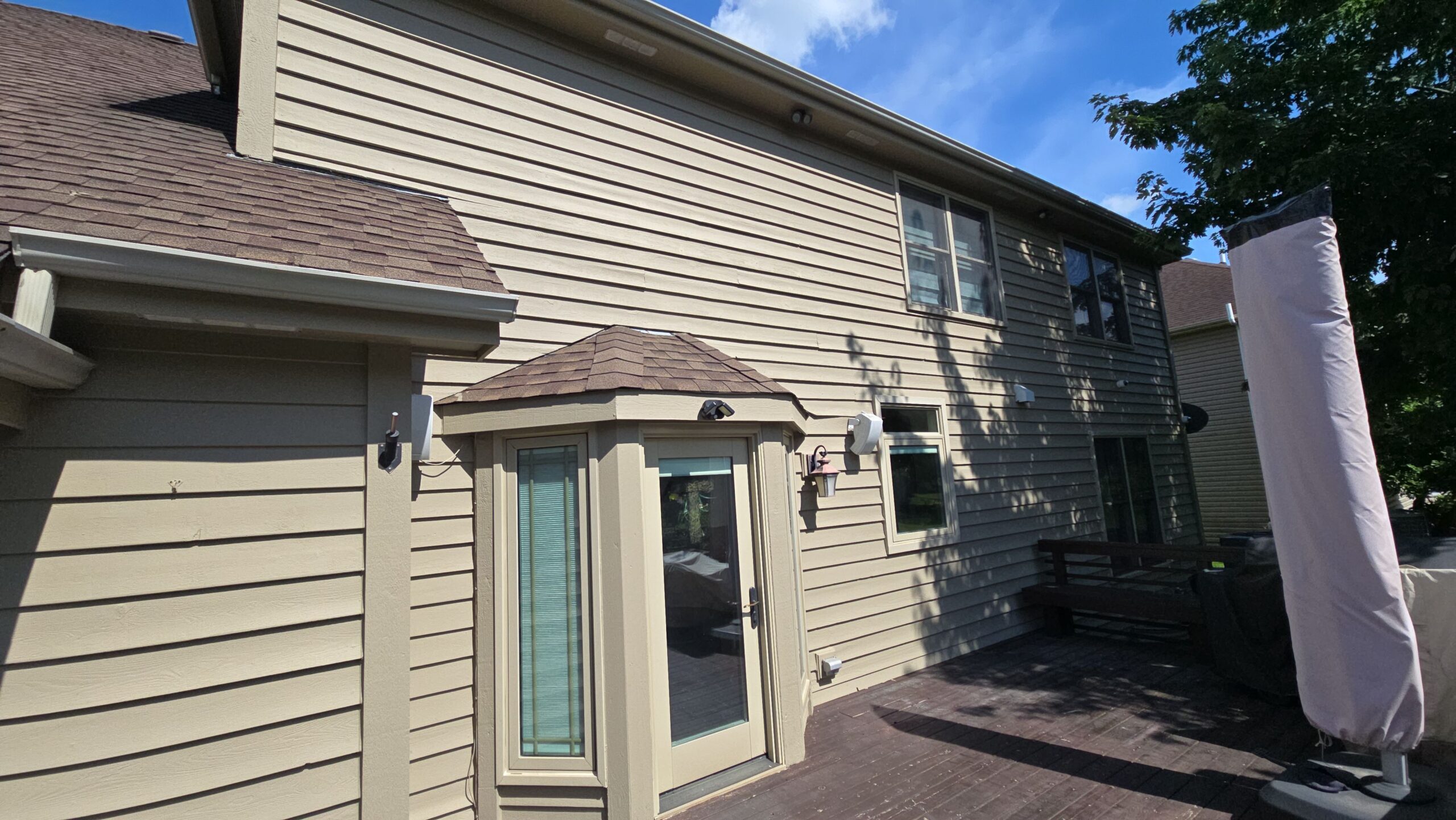 Exterior siding prepared for repainting after thorough cleaning
